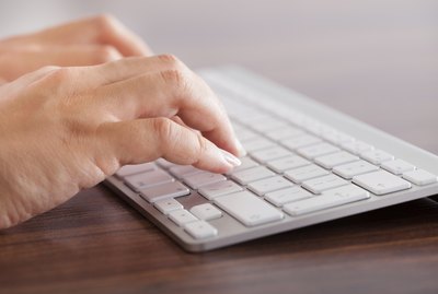 Female Hand Typing On Keyboard