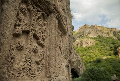 Stone carved medieval cross at Geghard monastery