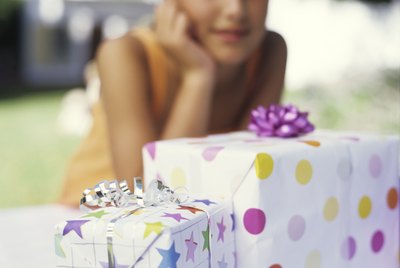 Girl (9-11) looking at gifts, close up