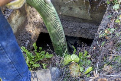 Worker emptying septic