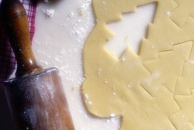 Dough, rolling pin, and christmas cookies
