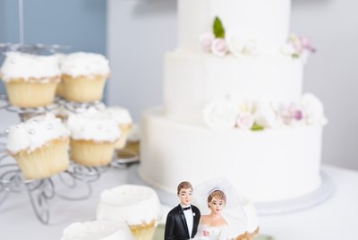 Wedding cake, cupcakes, and wedding figurines