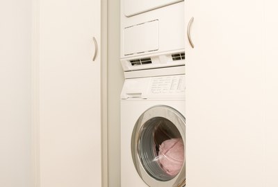 Washer and dryer stacked in closet