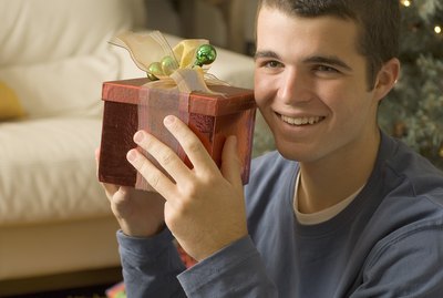 Teenage boy holding Christmas present