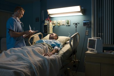 Doctor examining patient in hospital room