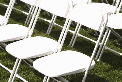 White folding chairs in rows