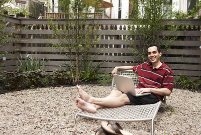 Relaxing on lounge chairs in urban backyard