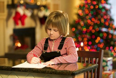 Girl writing Christmas wish list