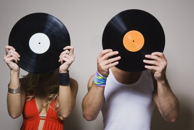 People holding vinyl records