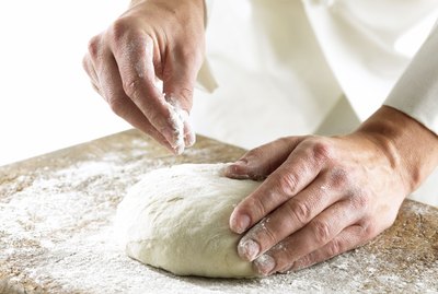 Chef rolling out dough