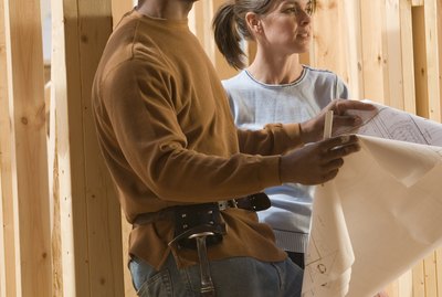 Architects with blueprints at construction site