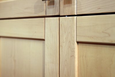 Contemporary wooden cabinets with metal knobs
