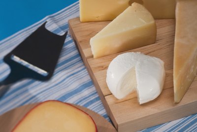 assorted cheese on cutting boards