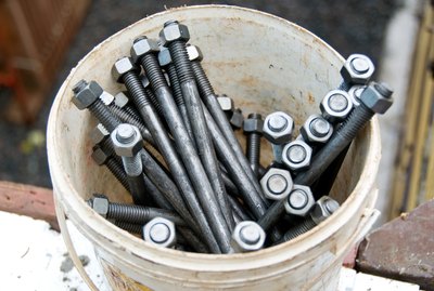 Close-up of bucket of nuts and bolts at construction site