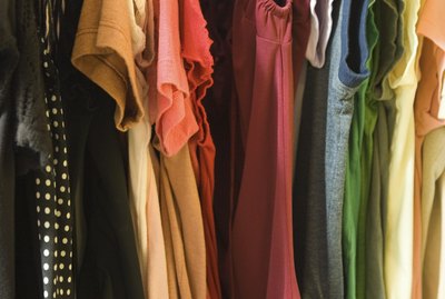 Clothes hanging in woman's closet