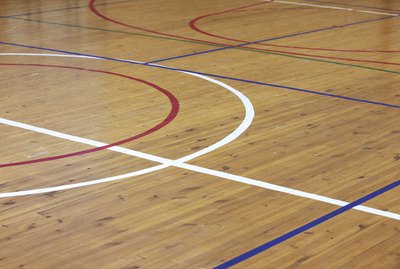 Wooden floor of sports hall with marking lines