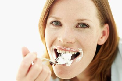 Close-up of a young woman eating dessert