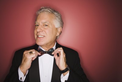 Man adjusting bow tie