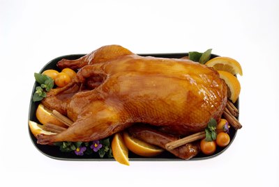 Glazed duck on platter with fruit
