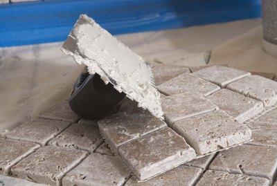 Grout on trowel by tiles