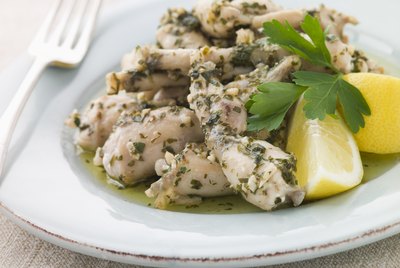 Frogs Legs Fried in Garlic and Herb Butter with Lemon