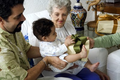 Mature man holding his son and receiving a gift