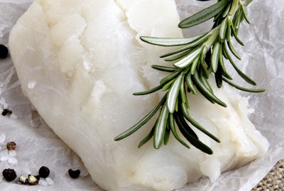 cod filled with rosemary on kitchen paper