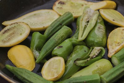 Green pepper, yellow squash and okra being sauteed in pan