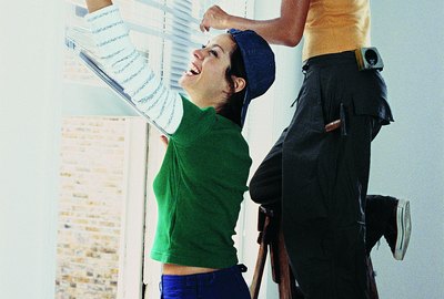 Young Women Installing Blinds