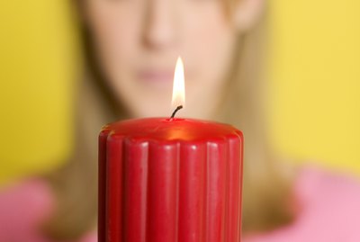 Woman holding lit candle