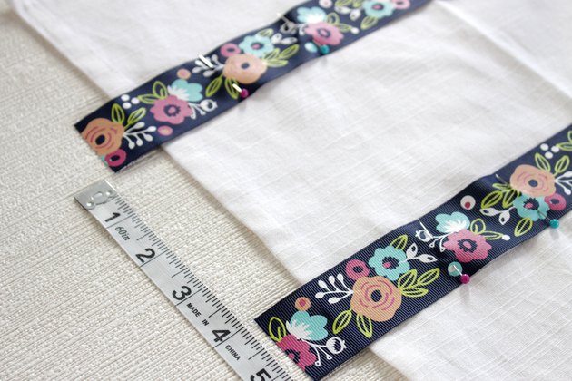 Instead of just hanging your towel over a cupboard door or throwing it on the counter, add a little ribbon to the top so you can give it a place of honor in your kitchen and hang it from your oven door.