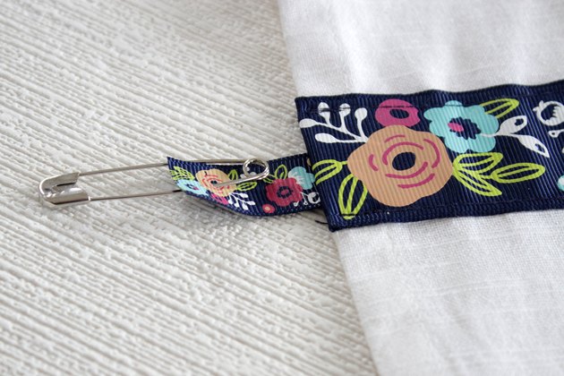 Instead of just hanging your towel over a cupboard door or throwing it on the counter, add a little ribbon to the top so you can give it a place of honor in your kitchen and hang it from your oven door.