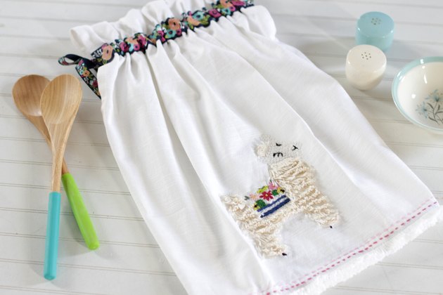 Instead of just hanging your towel over a cupboard door or throwing it on the counter, add a little ribbon to the top so you can give it a place of honor in your kitchen and hang it from your oven door.