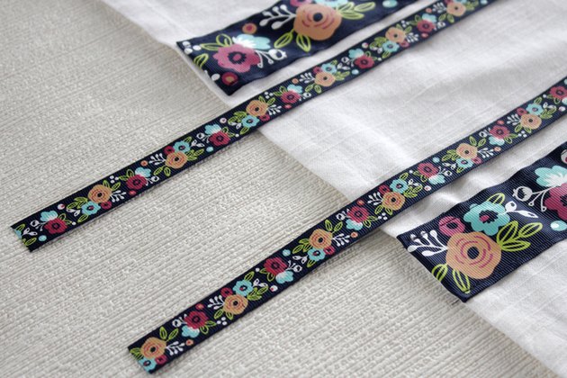 Instead of just hanging your towel over a cupboard door or throwing it on the counter, add a little ribbon to the top so you can give it a place of honor in your kitchen and hang it from your oven door.