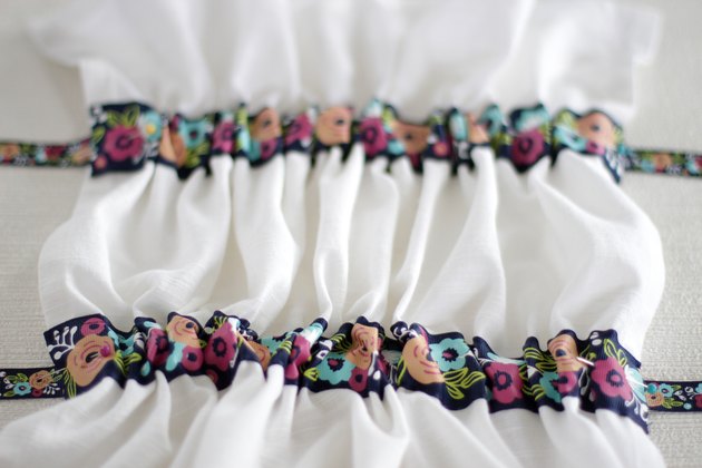 Instead of just hanging your towel over a cupboard door or throwing it on the counter, add a little ribbon to the top so you can give it a place of honor in your kitchen and hang it from your oven door.
