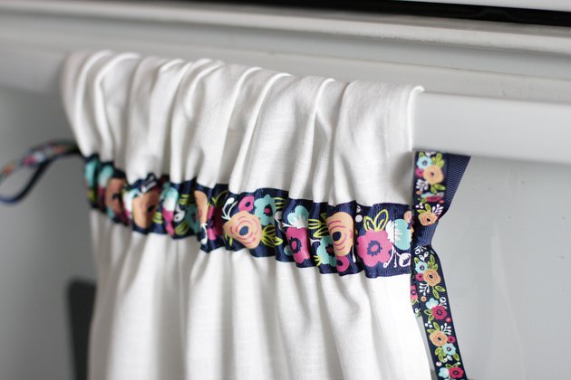 Instead of just hanging your towel over a cupboard door or throwing it on the counter, add a little ribbon to the top so you can give it a place of honor in your kitchen and hang it from your oven door.