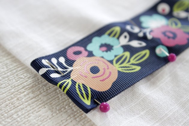 Instead of just hanging your towel over a cupboard door or throwing it on the counter, add a little ribbon to the top so you can give it a place of honor in your kitchen and hang it from your oven door.