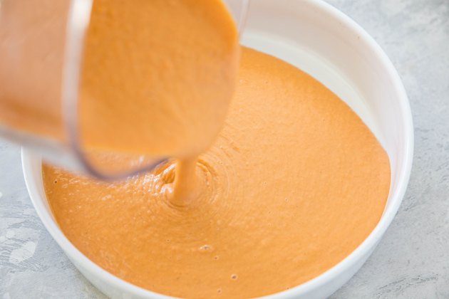 Souffle mixture being poured into a casserole dish