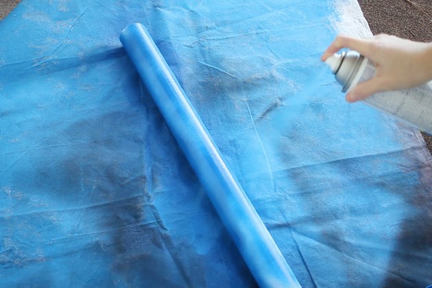 Spray painting mailing tube blue
