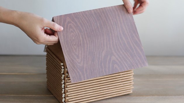 Gluing wood grain paper on top of cake boards