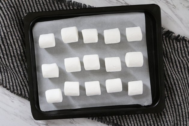Place marshmallows on parchment paper