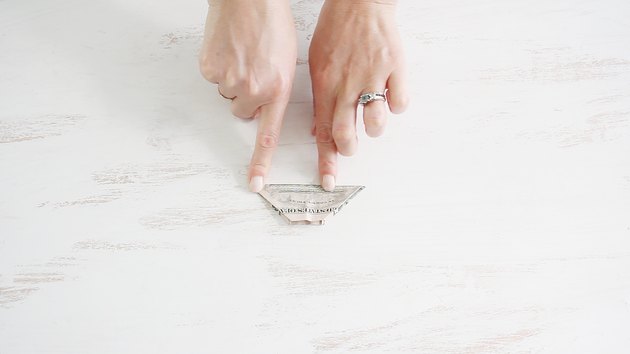 Folding bill in half