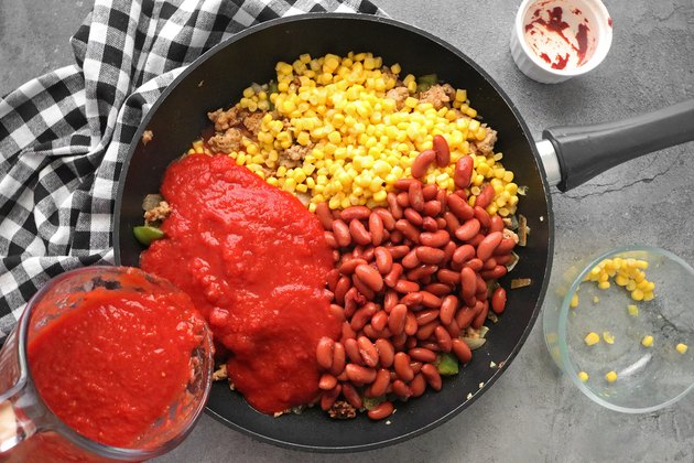 Add crushed tomatoes and simmer