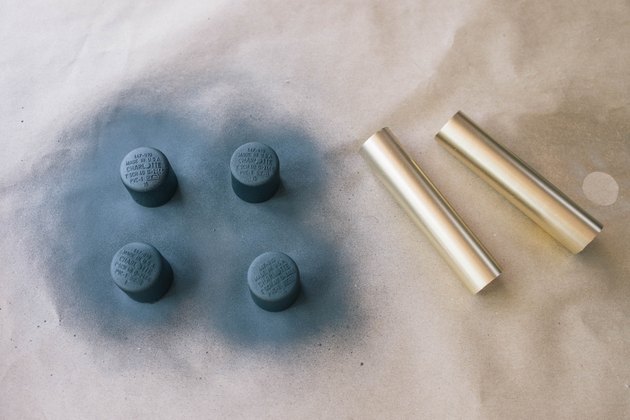 Four PVC caps painted black and two PVC pipes painted gold