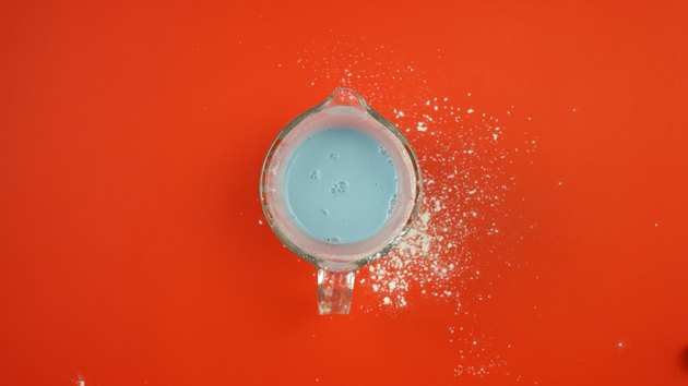 Adding food coloring to starch mixture for DIY Sidewalk Squirt Chalk