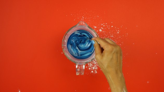 Adding food coloring to starch mixture for DIY Sidewalk Squirt Chalk