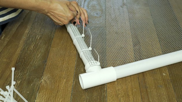 Fastening hardware cloth steel mesh to PVC frame with cable ties for DIY PVC Pipe Pet Gate