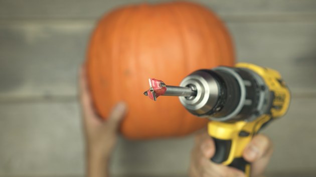 Using Forstner drill bit to cut a hole into a pumpkin to make DIY Pumpkin Keg