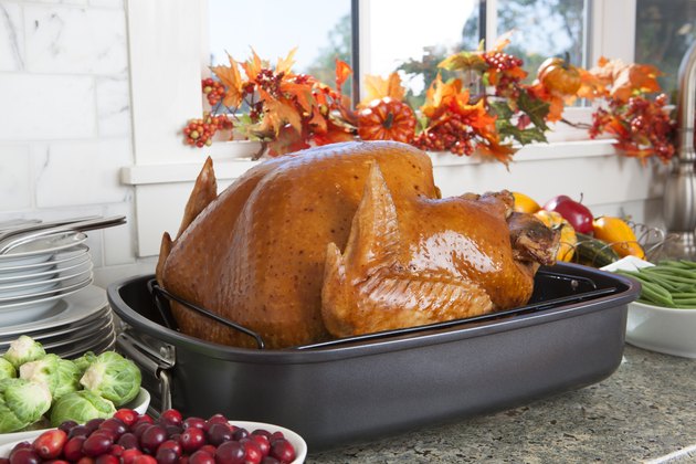 Cooked Turkey In Oven Roaster On Kitchen Counter