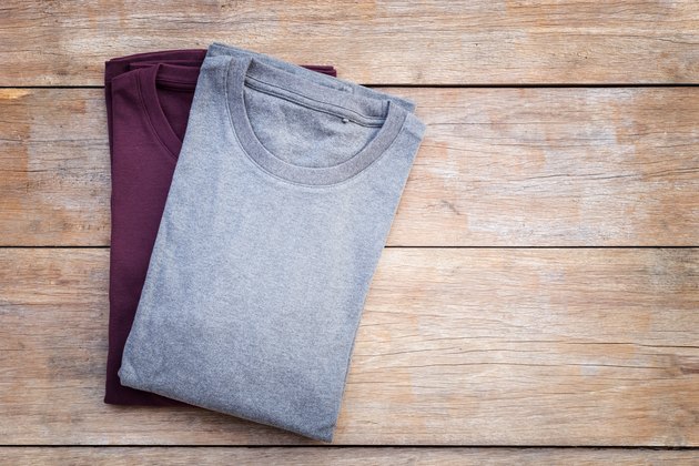Top view of color T-Shirt on grey wood plank